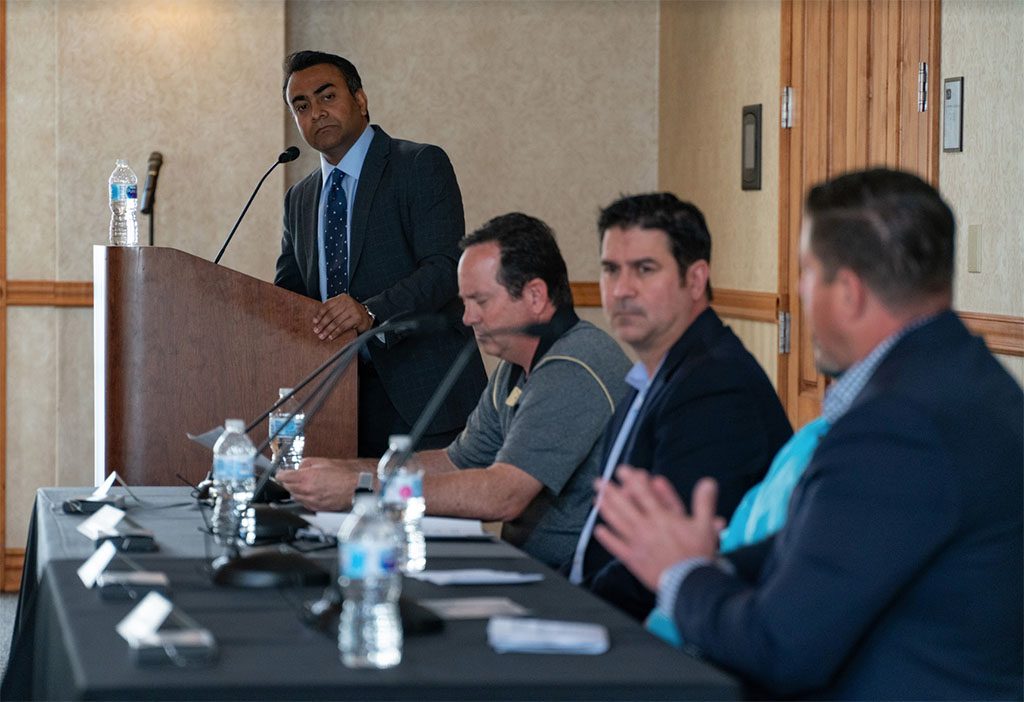 Four seminar speakers interacting